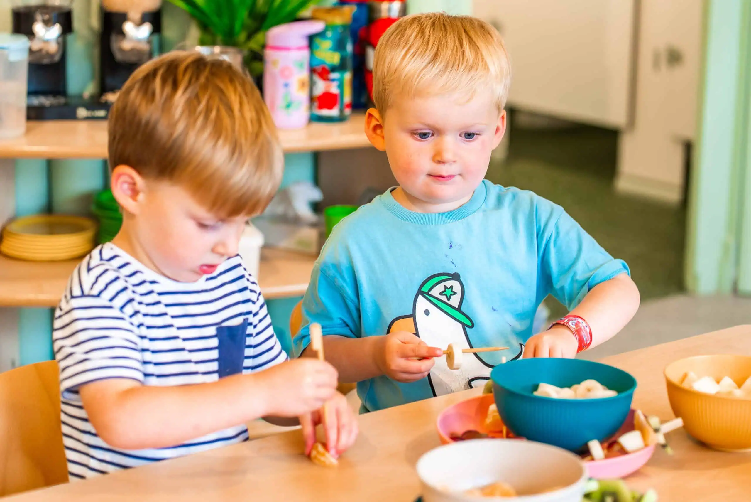 Children enjoying healthy snacks at Monkey Puzzle Two young children eating healthy snacks at Monkey Puzzle Day Nursery Radlett.