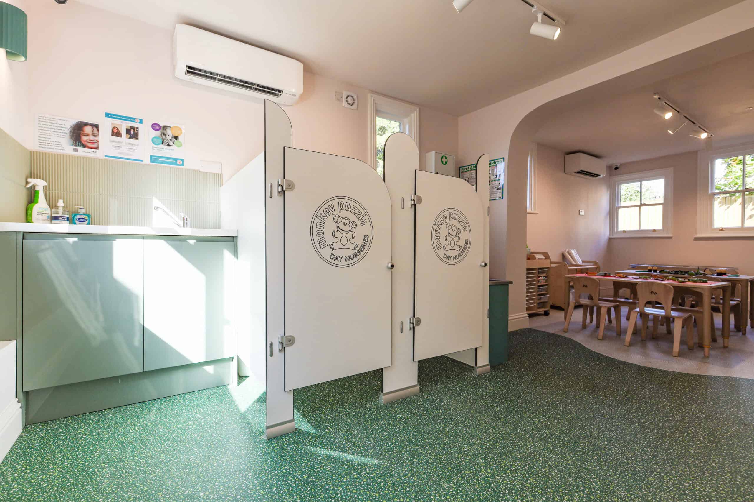 Indoor view of nursery with changing area and play space at Monkey Puzzle Radlett.