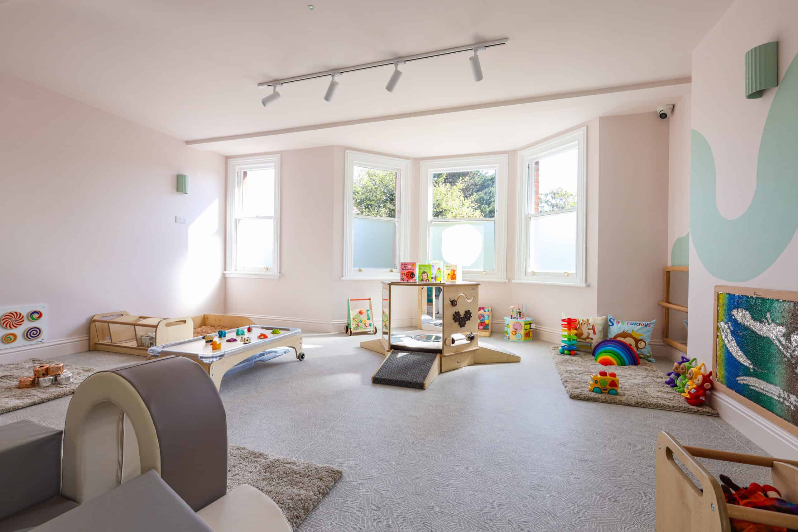 Bright and spacious nursery room with toys and play areas at Monkey Puzzle Radlett.