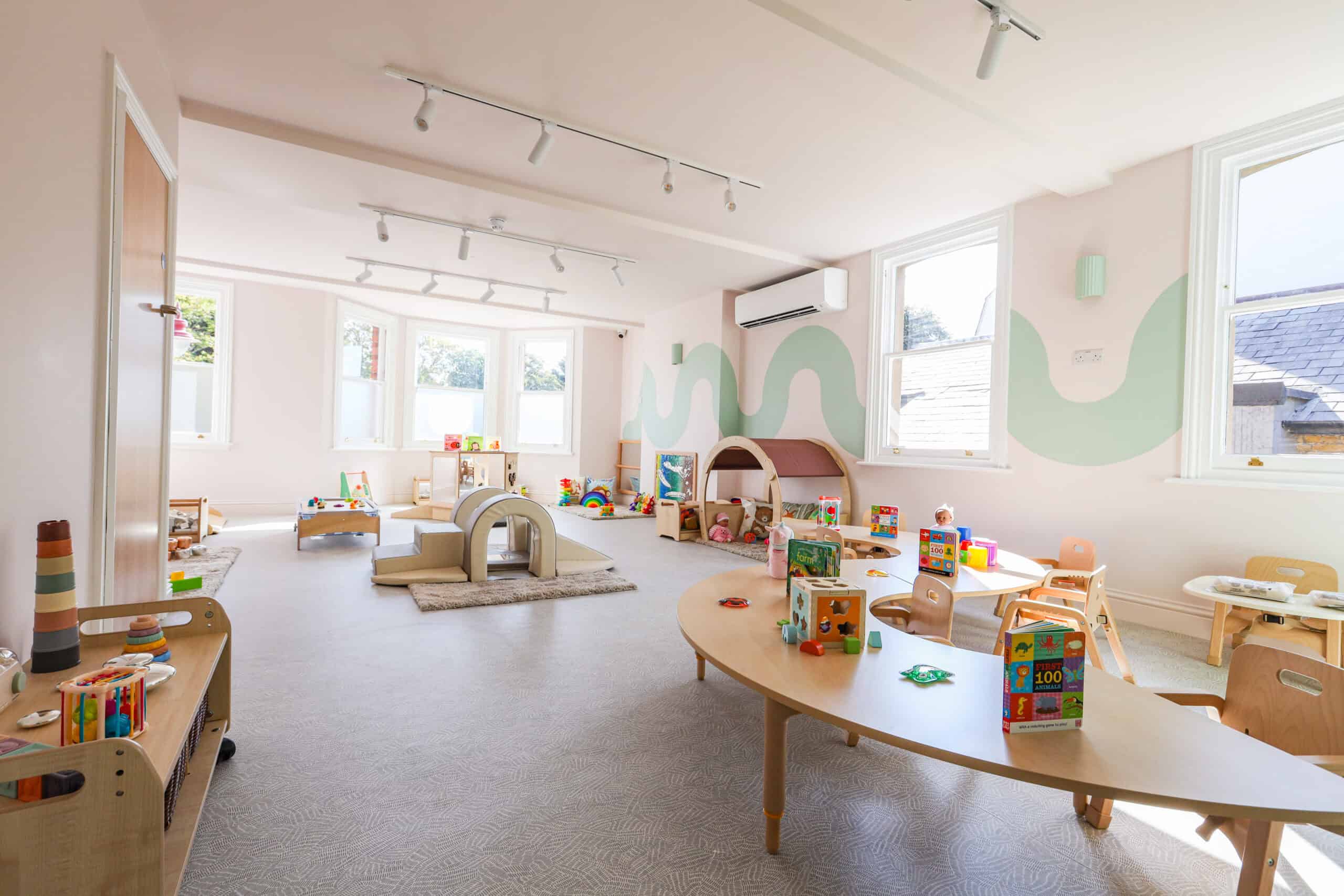 Bright and welcoming nursery room with toys and play areas at Monkey Puzzle Radlett.