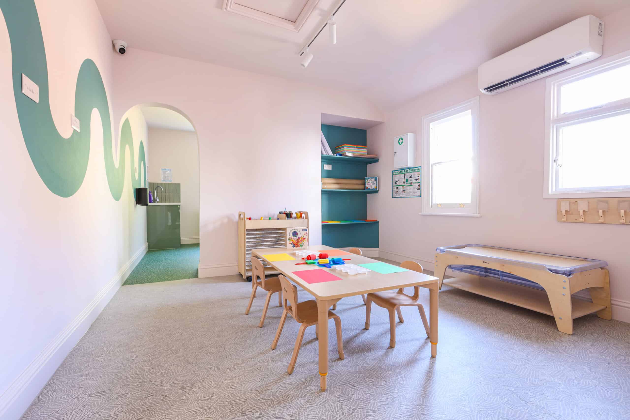 Bright, welcoming nursery room with toys and furniture for children.